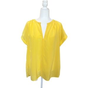 Tommy Bahama yellow silk top with short sleeves.